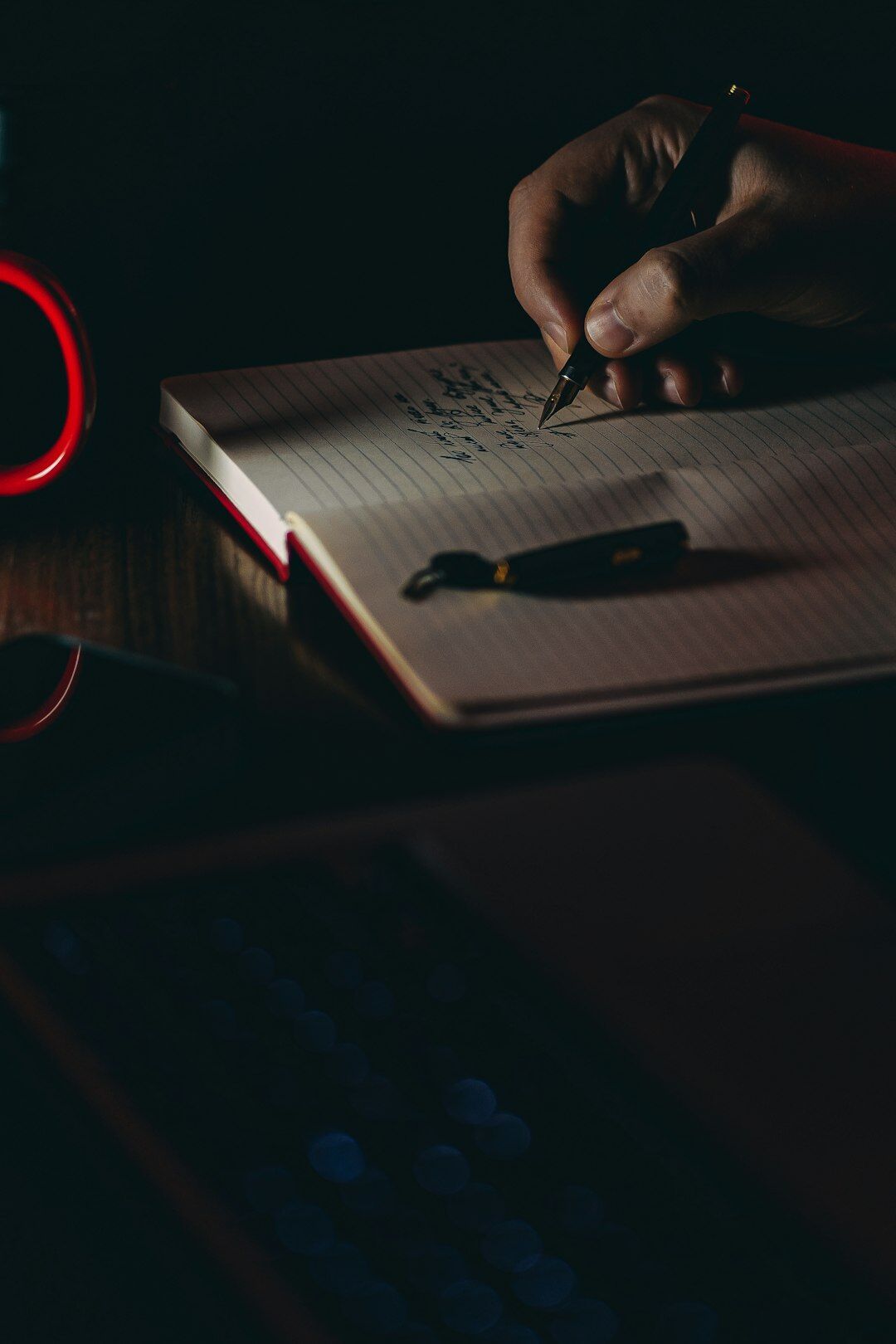 person writing in notebook